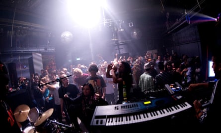 A view from the stage at club OT301, Amsterdam, which takes in a large crowd of people dancing under vibrant spotlights.