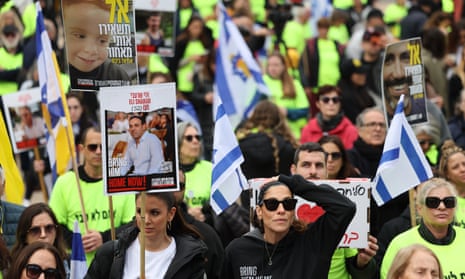 People wait to watch a live stream on a big screen reporting on the release of the three Israeli hostages Eli Sharabi, Or Levy and Ohad Ben Ami, to be transferred from Hamas to the Red Cross, in hostages square outside the Kirya military base in Tel Aviv, Israel, 08 February 2025.