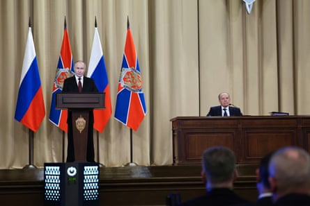 Putin speaking during a meeting of the Federal Security Service (FSB) board in Moscow in February, with the head of the FSB, Alexander Bortnikov, sitting at a table nearby.