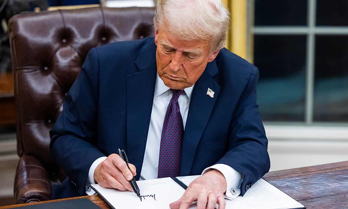 Donald Trump signing an executive agreement
