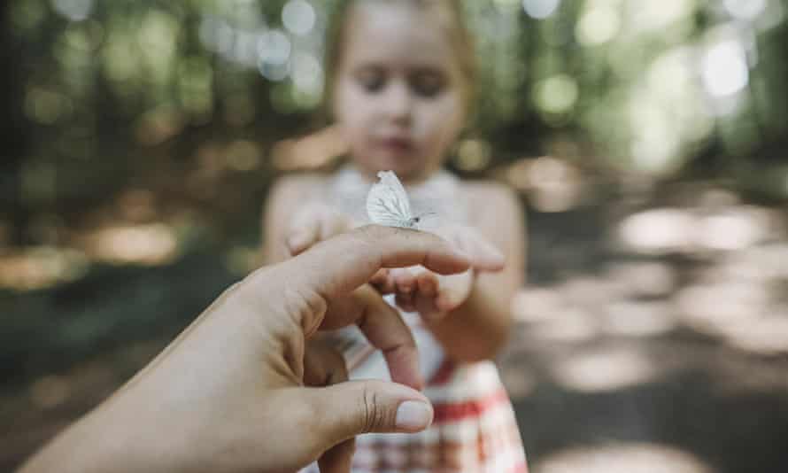 A butterfly on a woman's finger