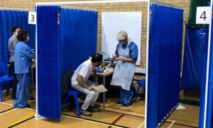 Dr Nolan Arulraj (in white) attending a vaccination centre in Cardiff.