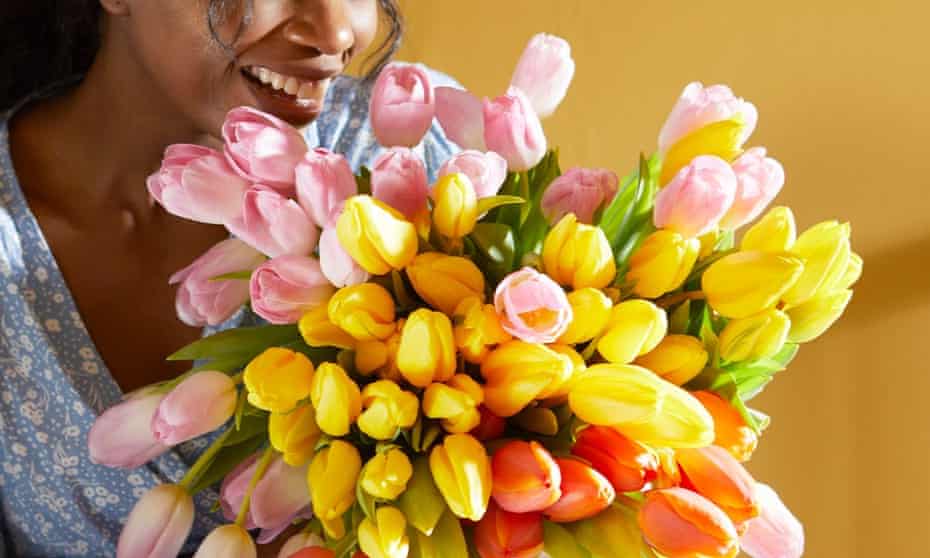 woman admiring B&W bouquet of tulips