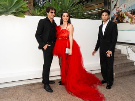 Mehdi Jibril, right, with a Tom Cruise lookalike and a woman in a red dress