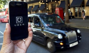 The Uber app logo displayed on a mobile telephone in central London