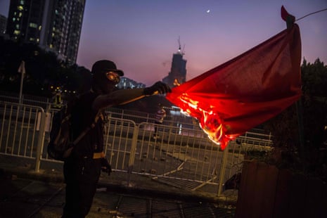 A protester sets fire to the Chinese national flag in the Sha Tin district.