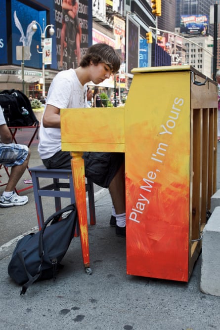 A teenager in New York plays a street piano, part of the public art project by Luke Jerram called ‘Play Me, I’m Yours’.