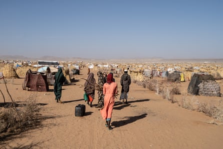 People at a refugee camp in a desert