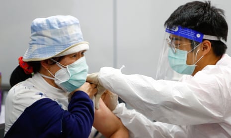 A woman receives the Moderna vaccine at a train station in Taipei, Taiwan.