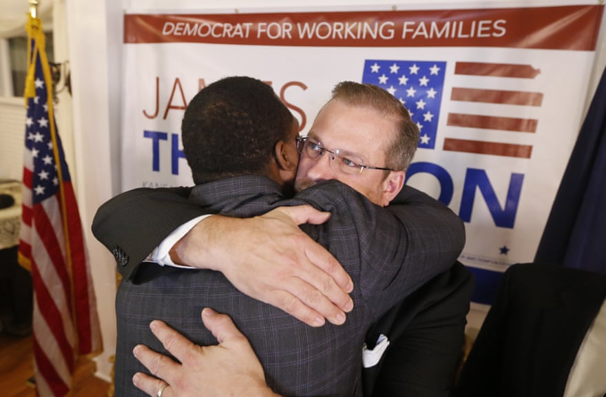 Thompson gets a hug from supporter Djuan Wash at the Murdock Theatre in Wichita.