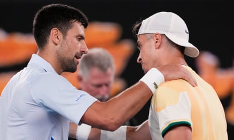 The champion and the teenage maestro share a warm embrace after Djokovic’s four-set win.