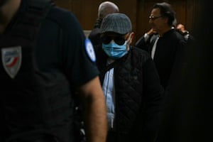 Husamettin Dogan wearing a hat, dark glasses and a facemask