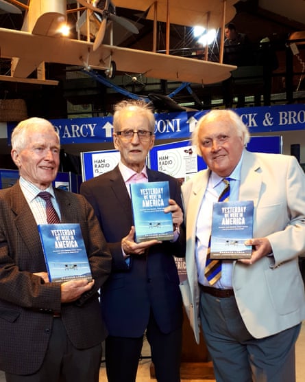 Brendan Lynch, Tony Alcock and Tony Kilmister, all wearing suits and holding up copies of Lynch’s book