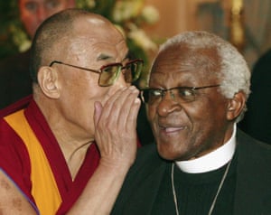The Dalai Lama whispers into the ear of Archbishop Desmond Tutu (R) in Brussels in 2006.