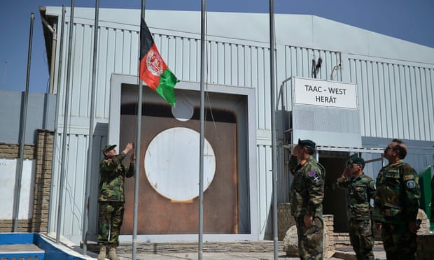 Afghan National Army (ANA) soldiers raise their national flag at the Italian Camp Arena military base, after Italian forces left.
