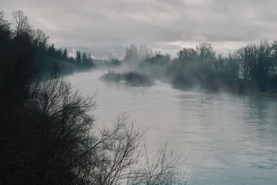 An view of a foggy river on a winter day