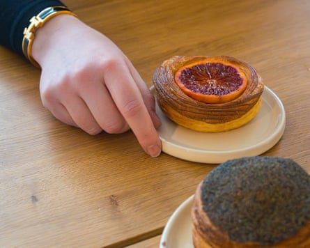 Two pastries and a hand with bracelet