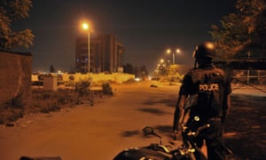 Malian police officers stand guard near the hotel hosting the EU military training mission in Bamako