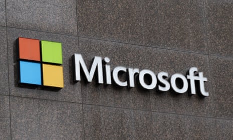 The square, red, green, yellow and blue Microsoft logo beside the word in white, Microsoft, on a building wall.