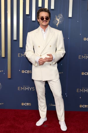 Outstanding actor in a drama nominee Pedro Pascal shades himself from the glow of his off white, double breasted Celine suit
