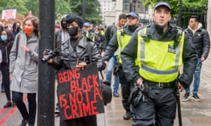 Police and campaigners at a Black Lives Matter march in London in June.