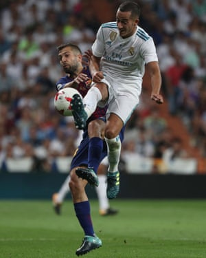 Real Madrid’s Lucas Vazquez tussles with Barcelona’s Jordi Alba.