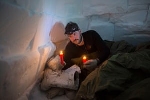 Canadian soldier Master Bombardier Jonathan Caron Corriveau holds survival candles that will be his only source of heat in an igloo he built on an Arctic Operations Advisors course. Soldiers learn from Inuit instructors how to build and sleep in improvised survival shelters at the Crystal City training area near Resolute Bay, where temperatures at times were as low as -50 degrees (-58 F) with the windchill.