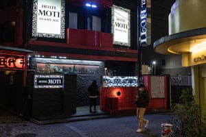 A woman enters a love hotel in Love Hotel Hill in Tokyo