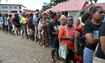 Voters queue at a polling station to vote during the Solomon Islands elections in the capital, Honiara