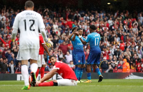 Walcott and Iwobi celebrate after the third was scored by Benfica’s Lisandro Lopez.