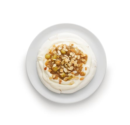 Snow white meringue with swoops of whipped cream and fresh fruit