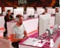 A group of people sitting in front of screens, wearing headphones, playing a video game