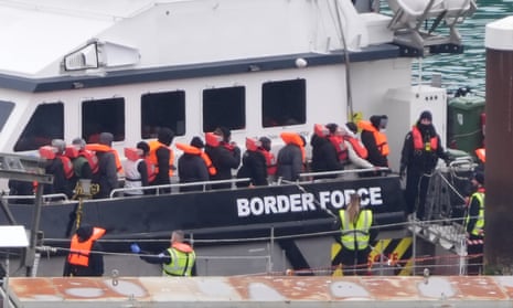 Border Force escorting migrants ashore