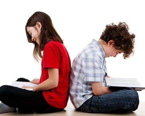 Kids sitting back to back, reading books