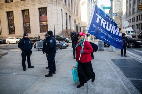 a person holds a large Trump flag