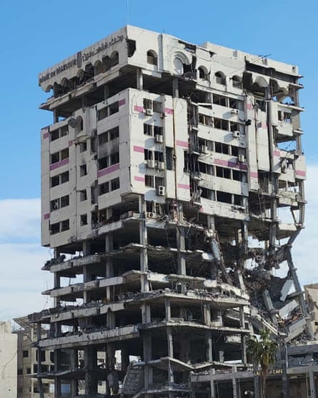 Multistorey building with the bottom half almost completely destroyed, while the upper half shows heavy damage.