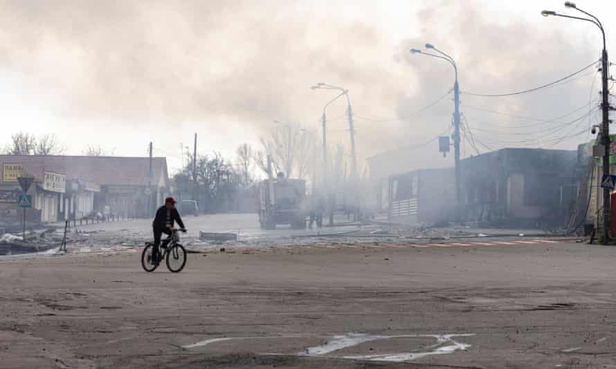 A man rides on a bicycle in front of a building after it was hit by shelling in Lysychansk, Luhansk region, Ukraine.