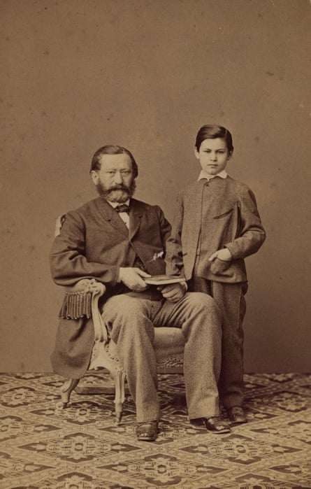 The young Sigmud Freud standing beside his father, who is seated in an armchair