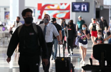 Passengers walk through the United Airlines terminal at George Bush Intercontinental Airport in Houston, Texas.