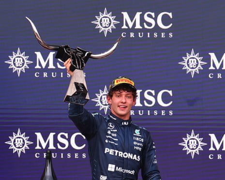 The Formula One driver Kimi Antonelli, racing for Mercedes, lifts the trophy on the podium after winning the United States Grand Prix at the Circuit of the Americas in Austin, Texas.