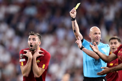 Bryan Cristante of Roma reacts after receiving a yellow card from referee Anthony Taylor.
