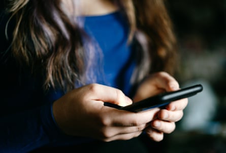 A woman holds a phone in her hands