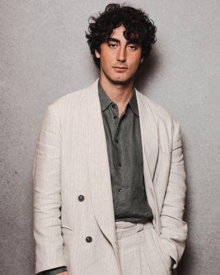 Anthony Ippolito poses in a beige suit over a green shirt at a photocall