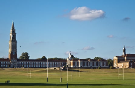 Playing fields with school buildings in the background