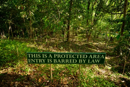 A sign reading ‘This is a protected area. Entry is barred by law’ in front of a natural wooded habitat in the Philippines.