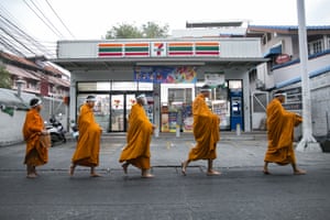 Bangkok, Thailand: Buddhist monks wear masks as they head to a market to collect alms