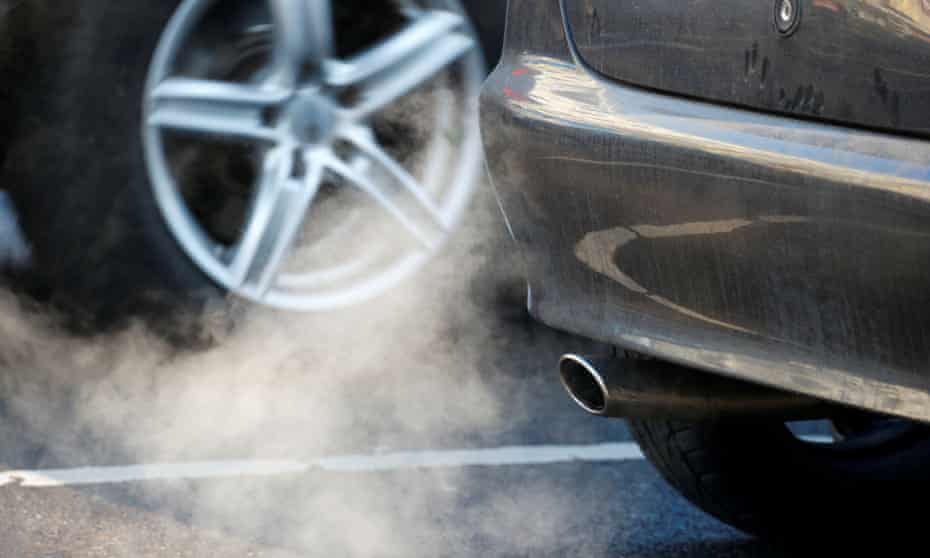 An exhaust pipe of a car on a street in Berlin, Germany