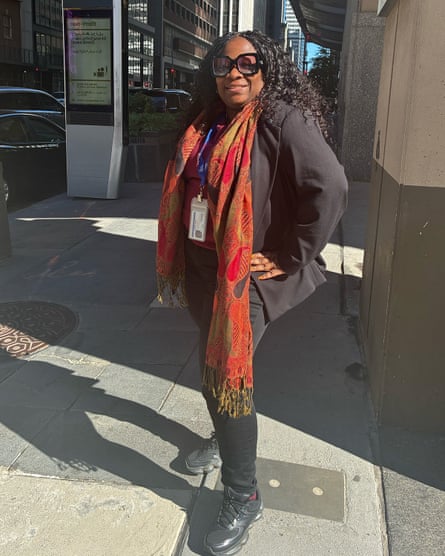a woman in a blazer, a scarf and black sneakers