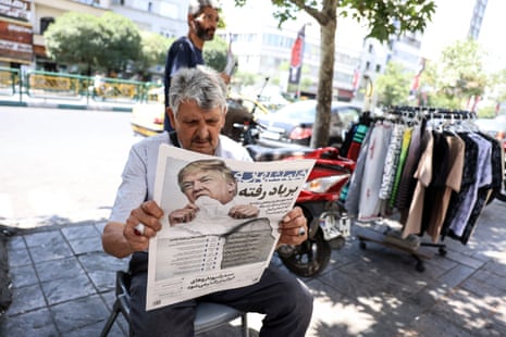 A man in Tehran, Iran, reads a copy of the Iranian daily newspaper Hamshahri bearing an image of Donald Trump and a headline that reads ‘Gone with the wind’.