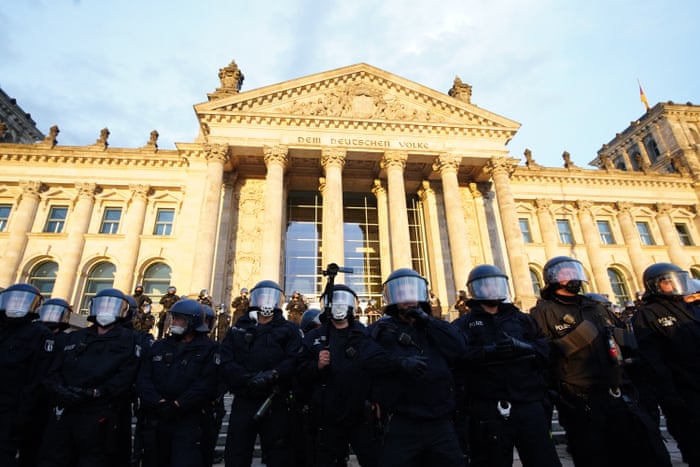 Police stand in front of the Reichstag building after demonstrators tried to climb the stairs after a protest against coronavirus pandemic regulations in Berlin, Germany, 29 August 2020.